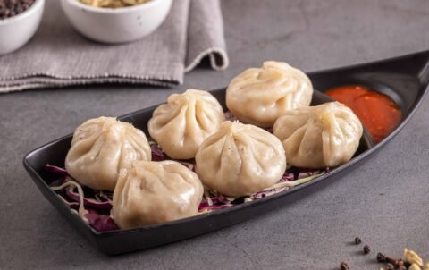 Steamed momos dumplings with red chutney at Tandoori Smoke Indian restaurant Bangkok