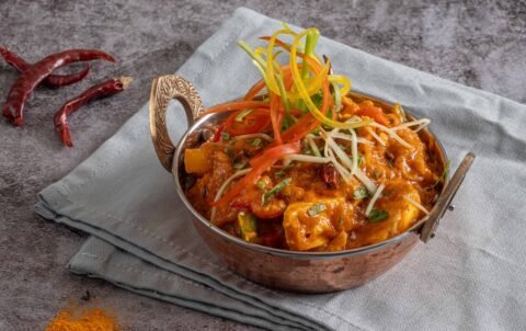 Kadai paneer with peppers and onion in an iron kadai at Tandoori Smoke, vegetarian Indian food in Bangkok