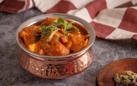Chicken tikka masala curry in a copper bowl at Tandoori Smoke Indian restaurant Bangkok