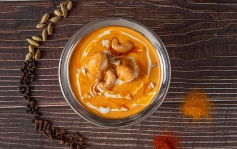 Creamy chicken korma with cashew nuts in a copper bowl at Tandoori Smoke Bangkok