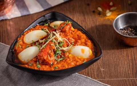 Egg curry (anda curry) with boiled eggs in spicy onion tomato masala at Tandoori Smoke Indian restaurant Bangkok