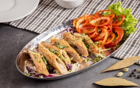 Chicken seekh kebab from the tandoor served with onion and salad at Tandoori Smoke Bangkok